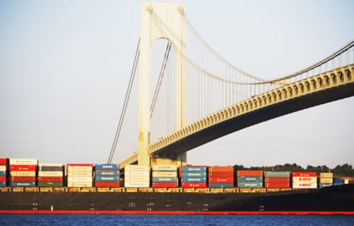 Container barge under Verrazano Narrows Bridge, New York City. Date : 2007