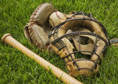 Old fashioned baseball equipment in grass. Date : 2006