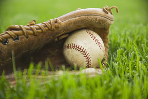 Baseball and mitt laying on grass. Date : 2006