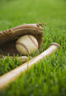 Baseball equipment laying on grass. Date : 2006