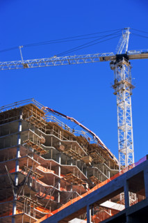 Low angle view of construction site and crane. Date : 2007