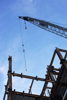 Low angle view of construction site and crane. Date : 2007