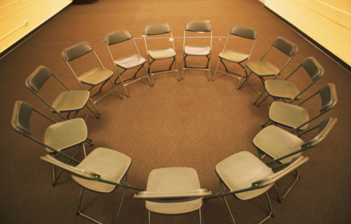 Empty folding chairs in circle. Date : 2007
