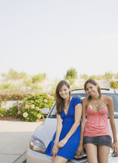 Young women sitting on car. Date : 2007