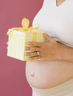 Pregnant woman holding gift. Date : 2007
