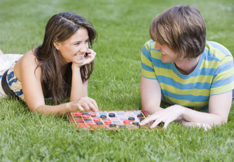 Couple playing checkers in grass. Date : 2007