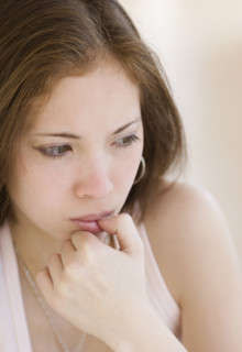 Close up of woman biting thumb. Date : 2007