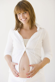 Pregnant woman with hands on belly. Date : 2007