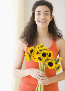 Woman holding bouquet of sunflowers. Date : 2007