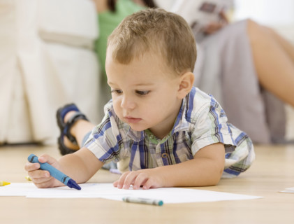Baby coloring on floor. Date : 2007