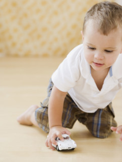 Baby playing with toy car. Date : 2007