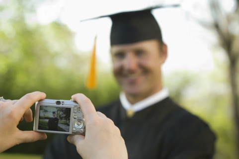 Male graduate having photograph taken. Date : 2007