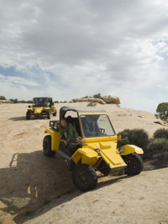 People in off-road vehicles on rock formation. Date : 2007