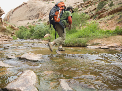 Man hiking through stream. Date : 2007