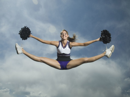 Cheerleader with pom poms jumping. Date : 2007