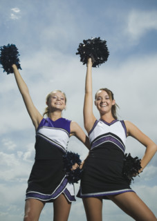 Two cheerleaders holding pom poms. Date : 2007