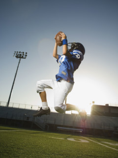 Young football player catching ball. Date : 2007