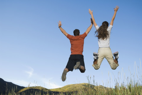Rear view of couple jumping, Utah, United States. Date : 2007
