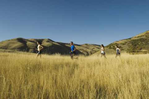 Group of people running in field, Utah, United States. Date : 2007