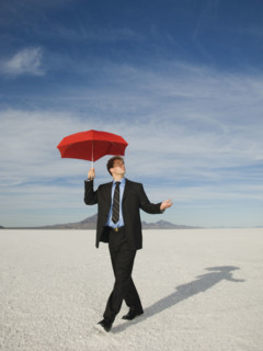 Businessman walking with umbrella, Salt Flats, Utah, United States. Date : 2007