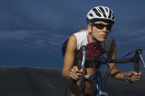 Woman cycling at night, Utah, United States. Date : 2007