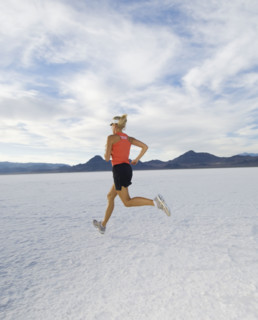 Woman running on salt flats, Utah, United States. Date : 2007