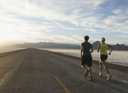 Couple running on road, Utah, United States. Date : 2007