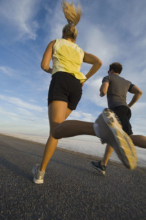 Couple running on road, Utah, United States. Date : 2007