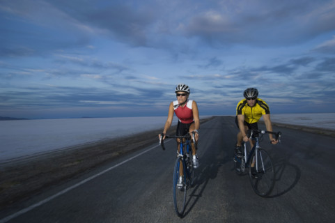 Couple cycling on road, Utah, United States. Date : 2007