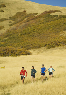 Group of people running in field, Salt Flats, Utah, United States. Date : 2007