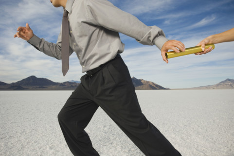 Businessman taking baton in relay race, Salt Flats, Utah, United States. Date : 2007