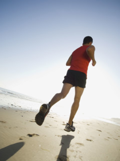 Man jogging on beach. Date : 2007