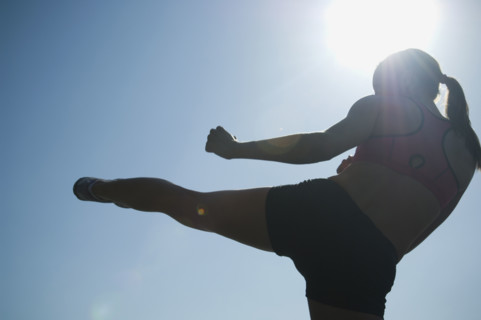 Rear view of woman kicking. Date : 2007