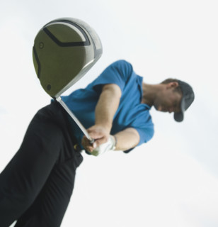 Man swinging golf club. Date : 2007