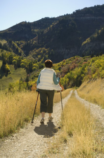 Senior woman walking with hiking poles, Utah, United States. Date : 2007