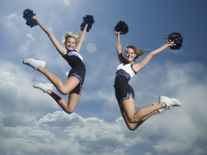 Cheerleaders with pom poms jumping. Date : 2007