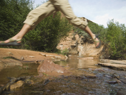 Woman jumping over stream. Date : 2007