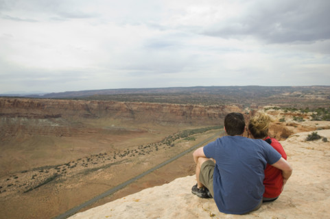 Couple looking over edge of cliff. Date : 2007