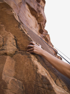 Close up of woman’s arm rock climbing. Date : 2007