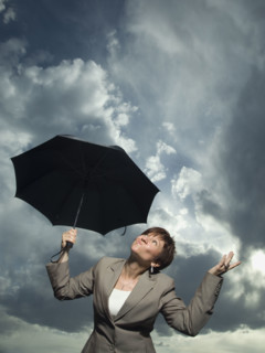 Businesswoman holding umbrella. Date : 2007