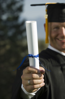 Male graduate holding diploma. Date : 2007