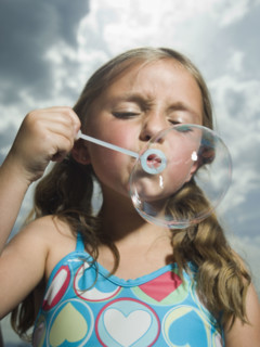 Young girl blowing bubble. Date : 2007