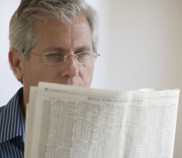 Man reading newspaper.
