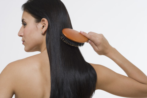 Woman brushing hair.