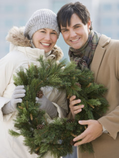 Couple holding wreath.