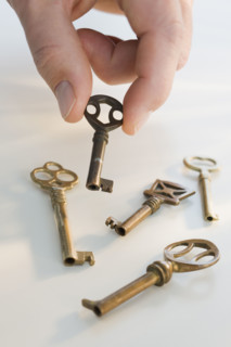 Man picking up old fashioned key.