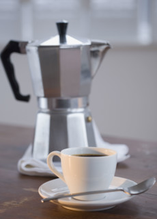 Espresso in front of coffee pot.