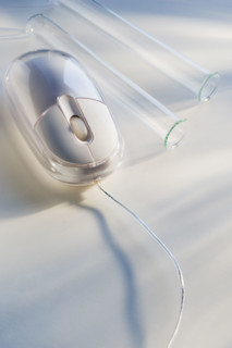 Empty vials next to computer mouse.