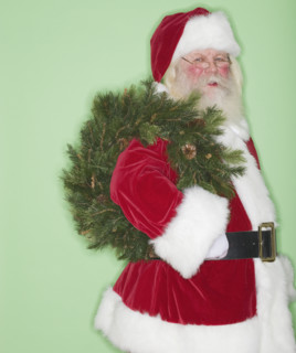 Santa Claus holding wreath.