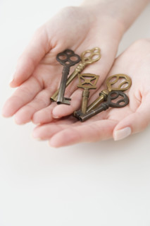 Old fashioned keys in woman’s hands.